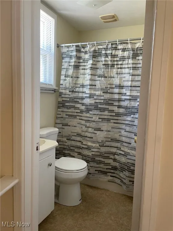 Bathroom featuring vanity, a shower with curtain, and tile patterned flooring