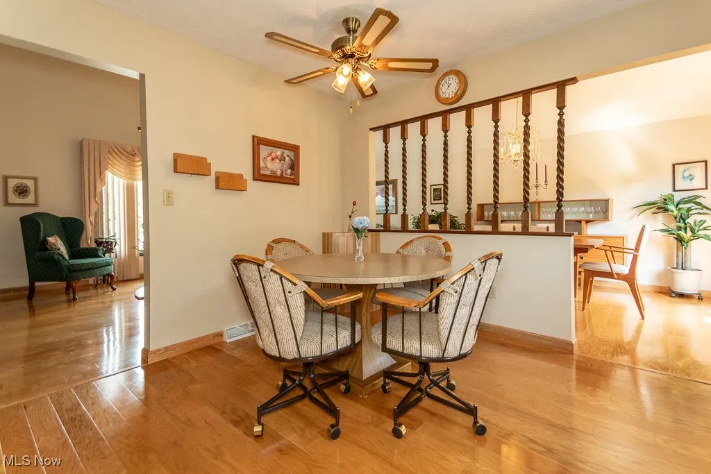 Eat in Kitchen with light wood floors and a ceiling fan