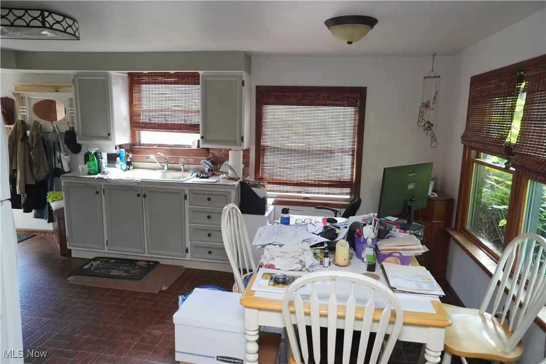 Kitchen featuring light countertops, brick patterned flooring, and freestanding​​‌​​​​‌​​‌‌​‌‌​​​‌‌​‌​‌​‌​​​‌​​ refrigerator