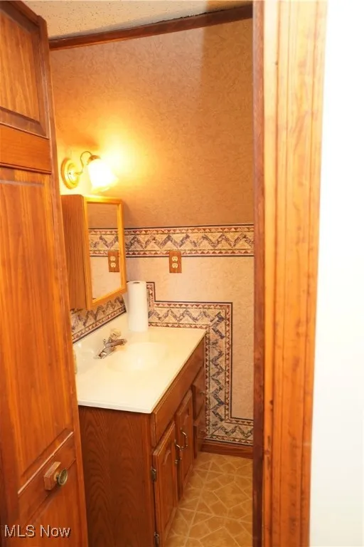 Bathroom featuring vanity and light tile patterned flooring