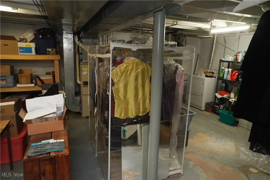 Unfinished below grade area with washer / dryer and heating unit