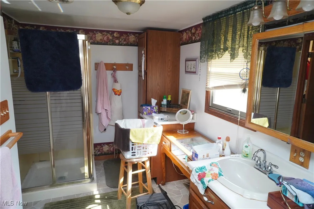 Bathroom with vanity and a stall shower