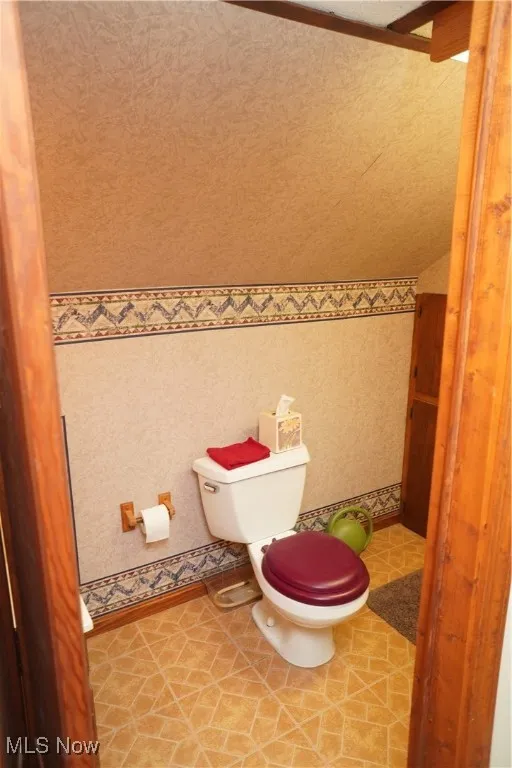 Bathroom featuring toilet and light tile patterned floors