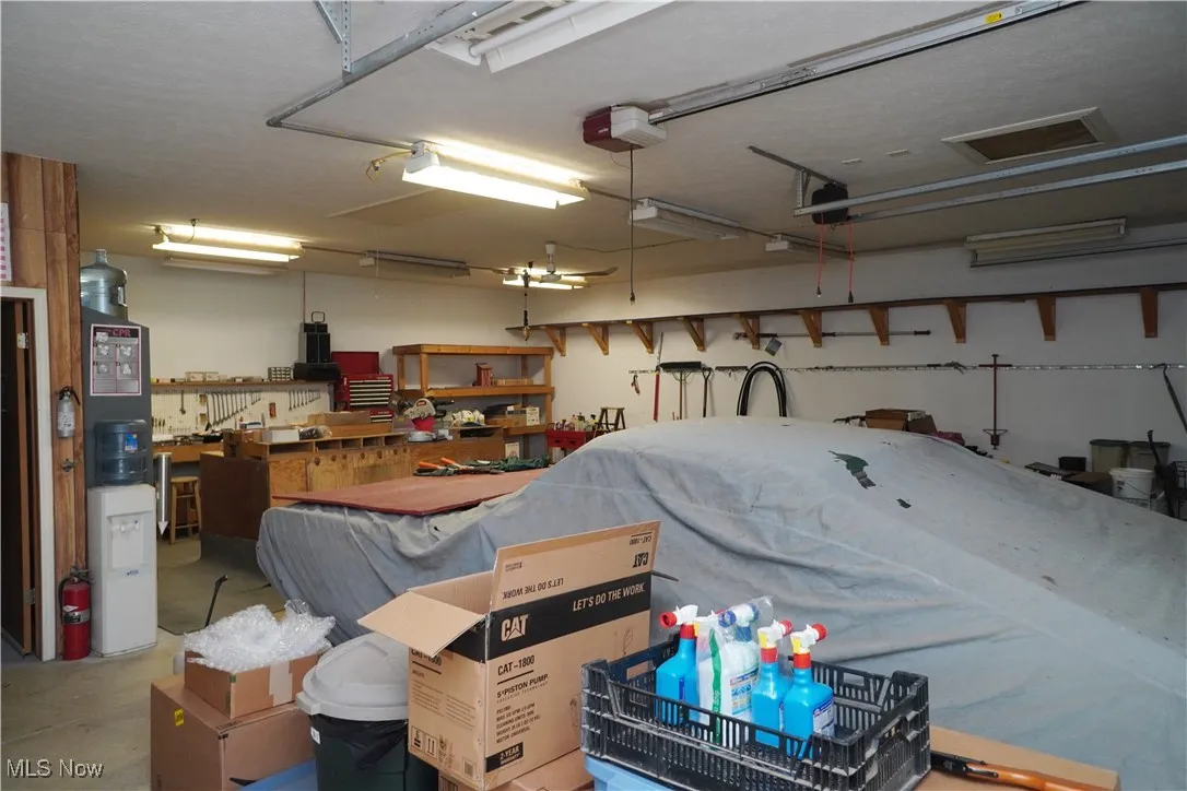 Garage featuring a garage door opener and a workshop area