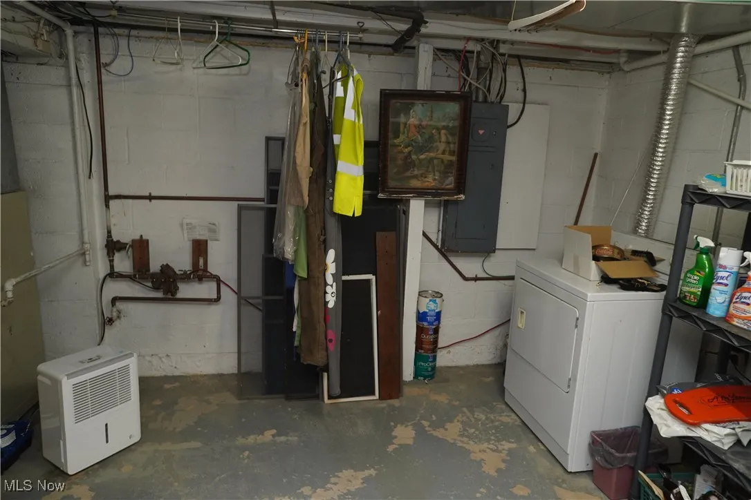 Unfinished basement with washer / dryer and electric panel