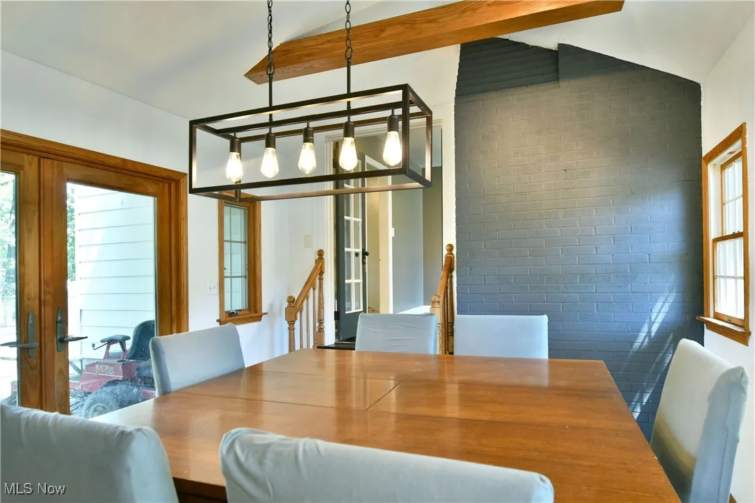 Dining area featuring french doors and brick wall