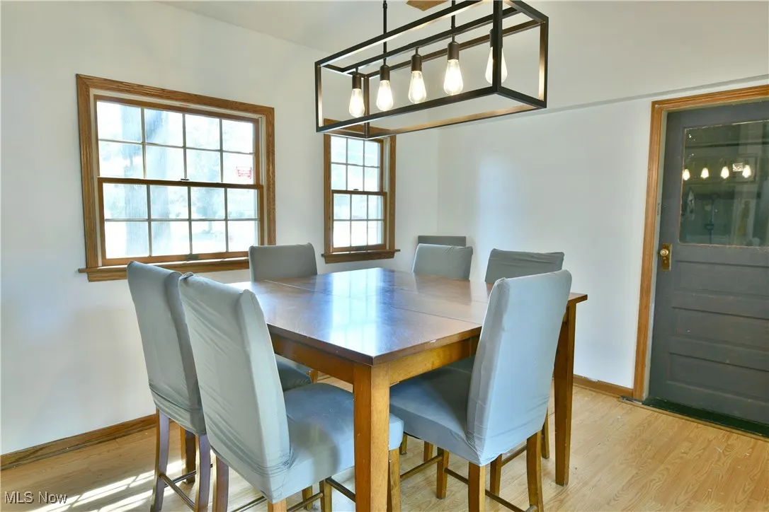 Dining room featuring light wood-type flooring and baseboards