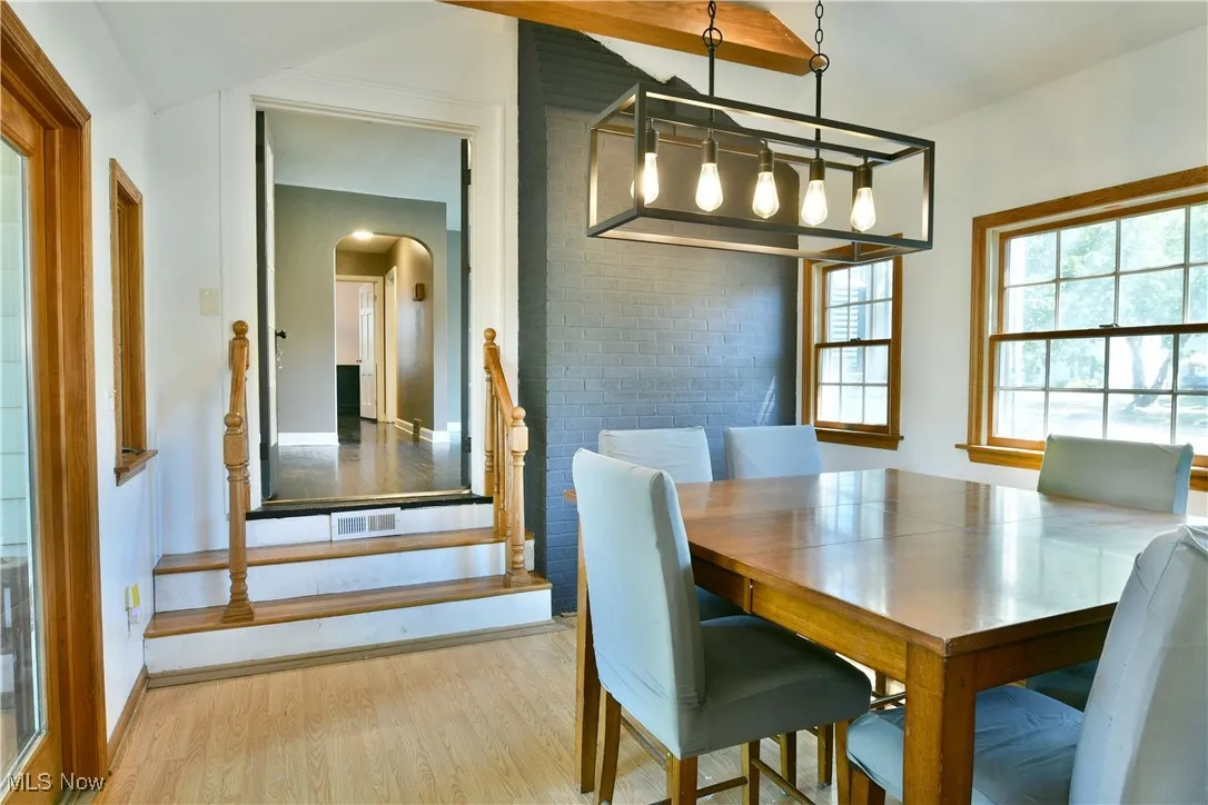 Dining room featuring wood finished floors and arched walkways