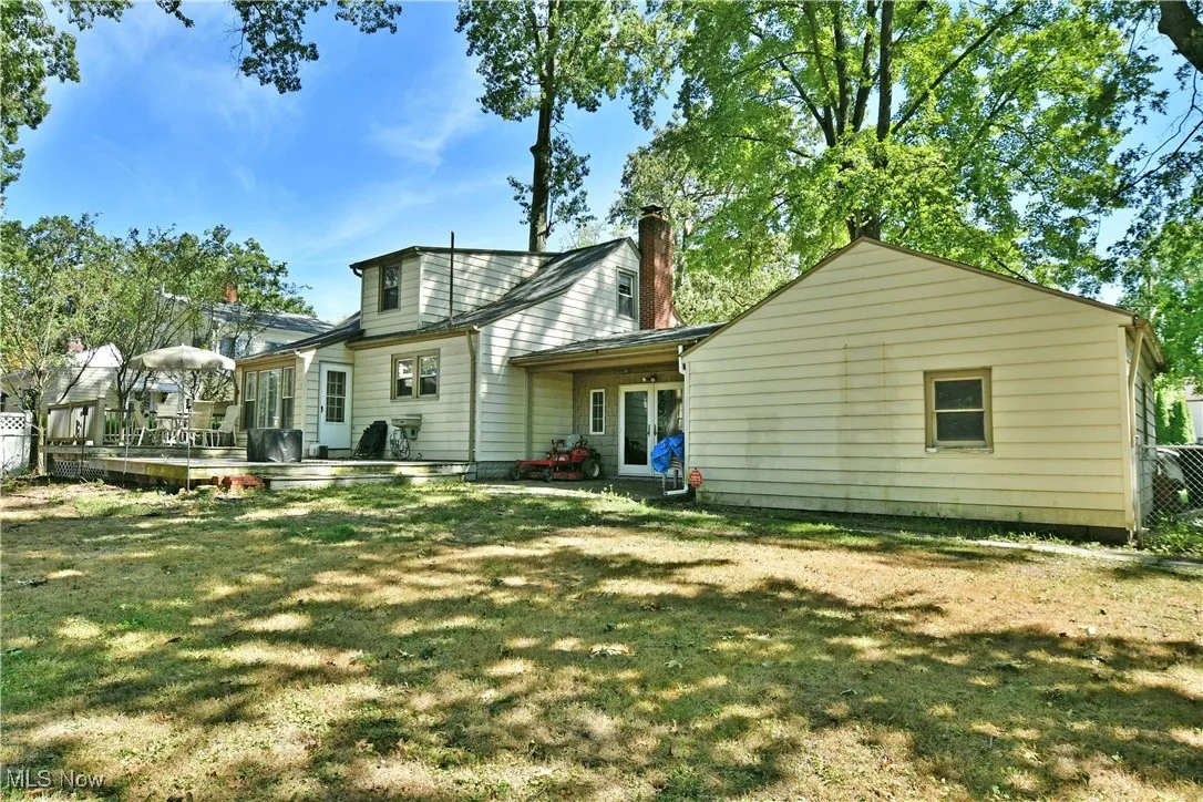 Back of house with a chimney and a patio area