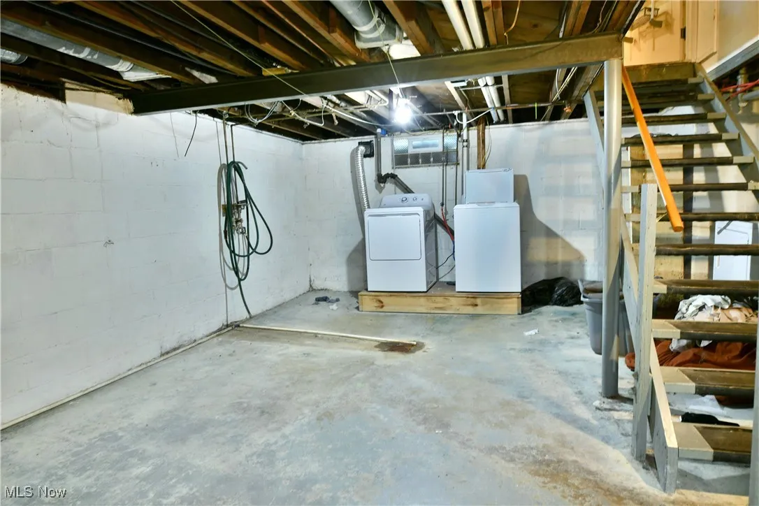Unfinished basement featuring stairs and separate washer and​​‌​​​​‌​​‌‌​‌‌​​​‌‌​‌​‌​‌​​​‌​​ dryer