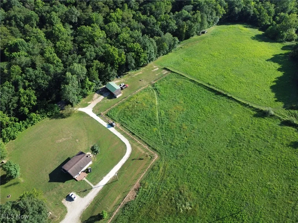 View of property location with a forest and rural landscape