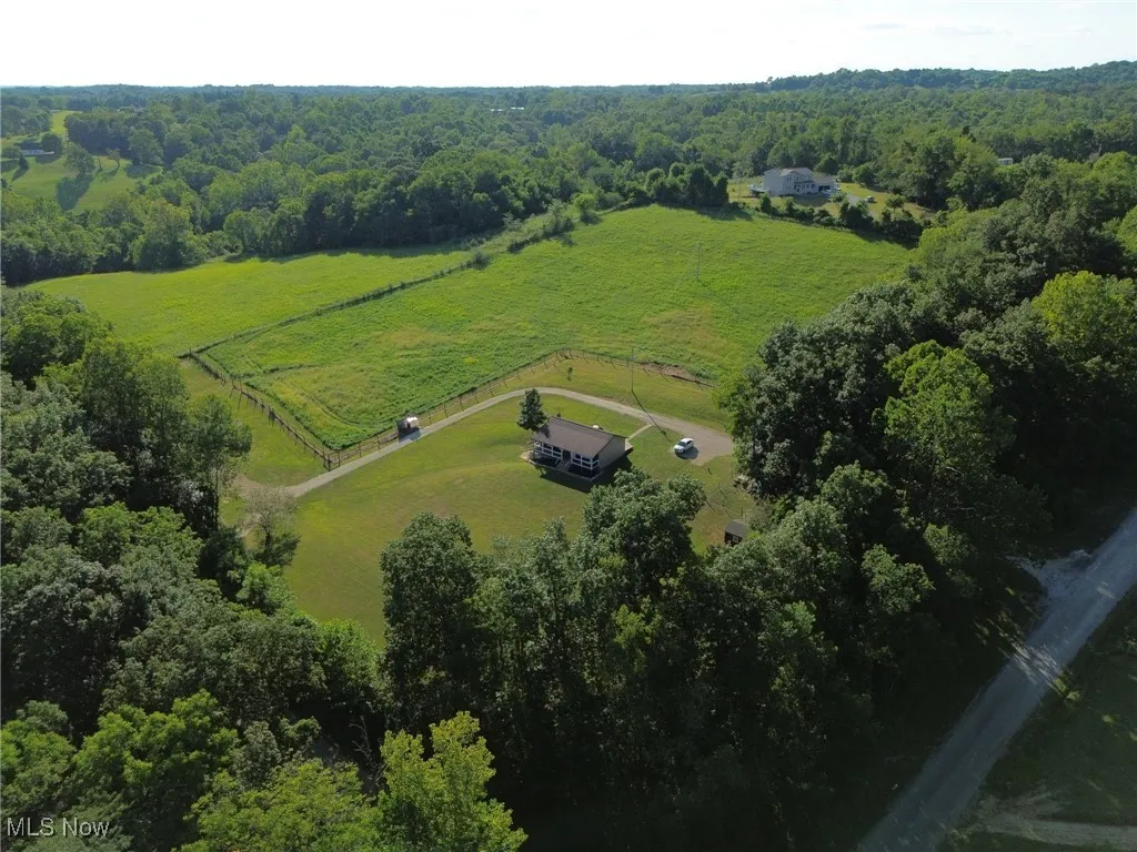 Aerial view of sparsely populated area with a heavily wooded area