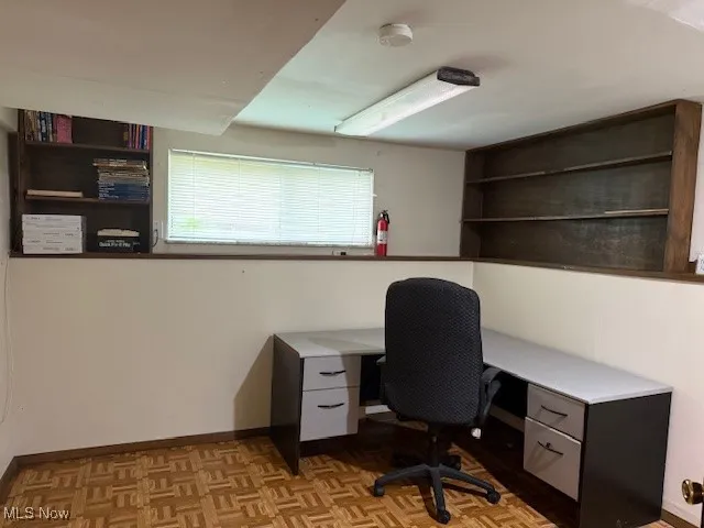 Office desk and bookshelves with plenty of room for storage.