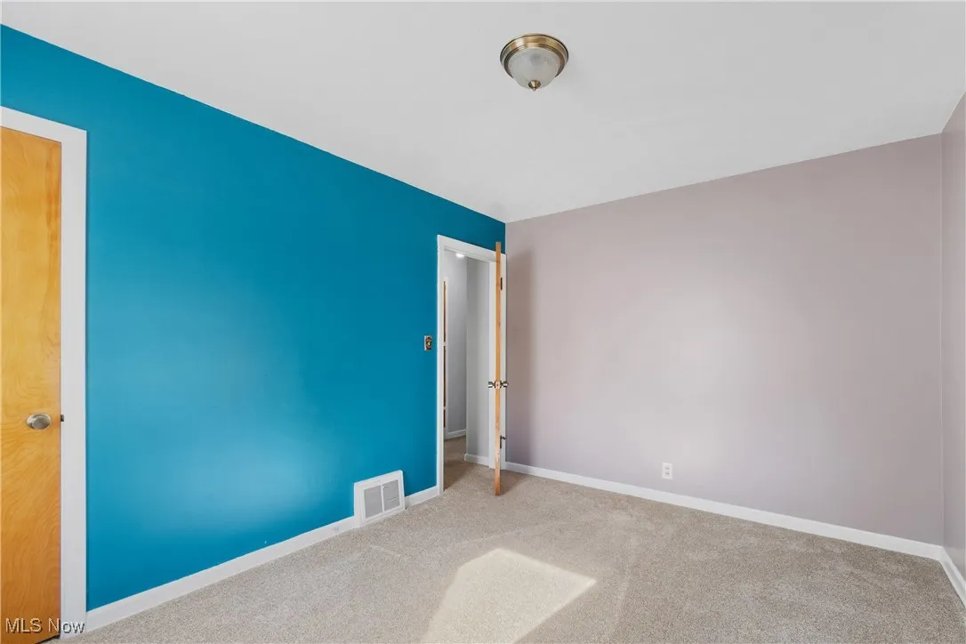 Unfurnished bedroom featuring carpet and baseboards