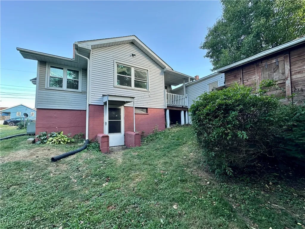 Back view of home and yard