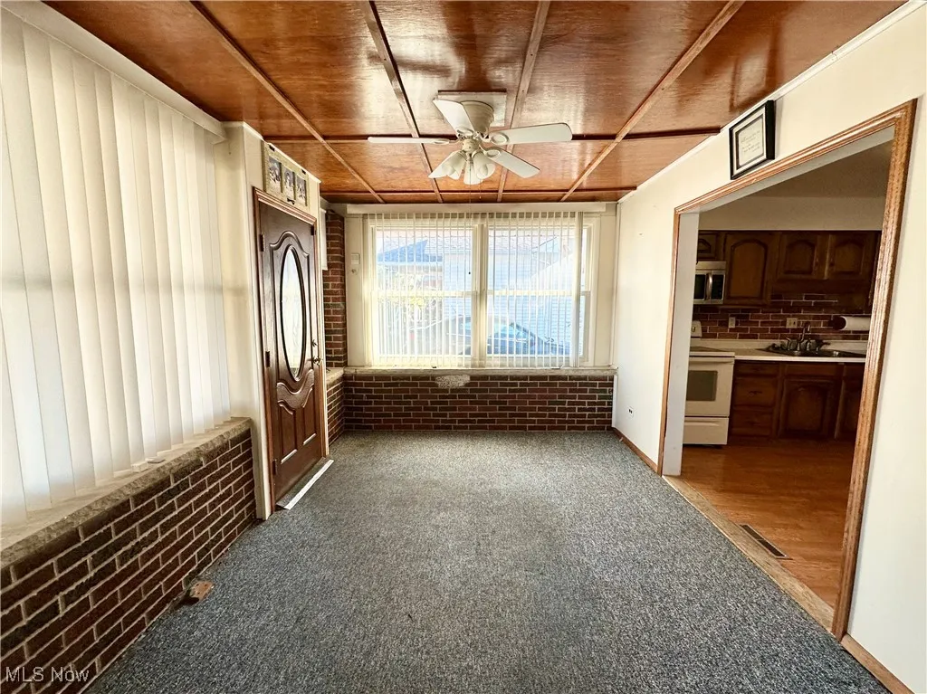 Plenty of natural light, carpet floors, and ceiling fan