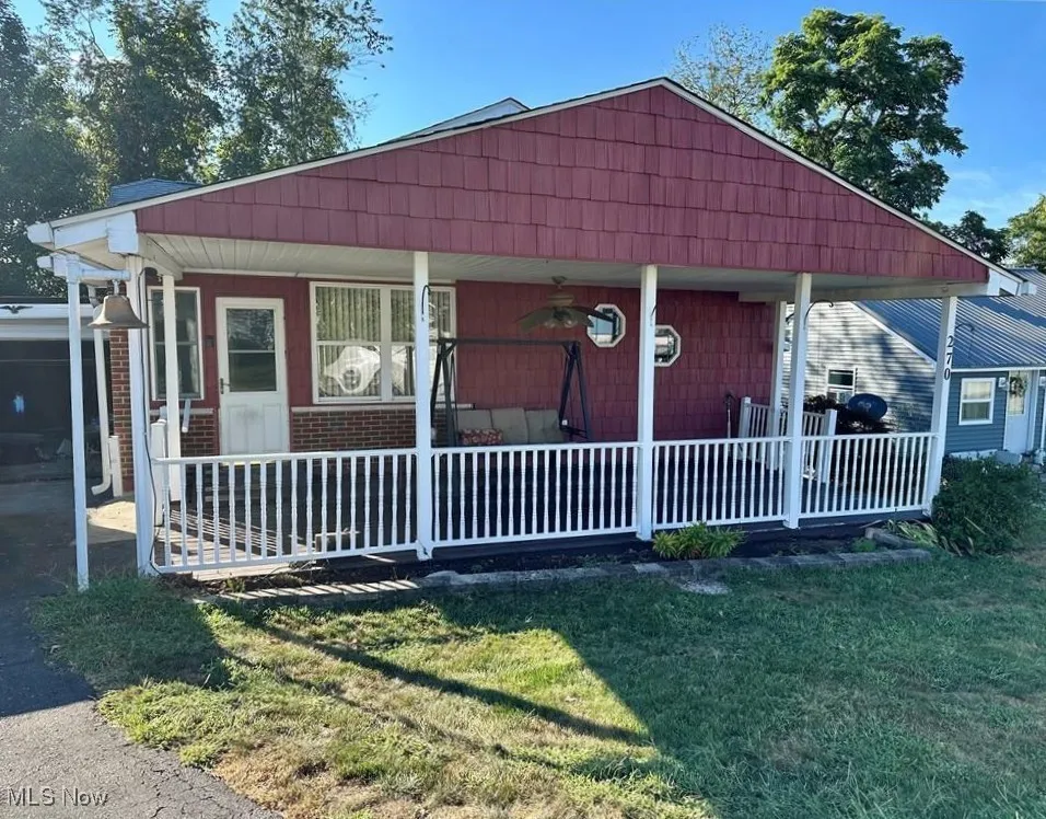 Bungalow-style house featuring covered porch and a front yard