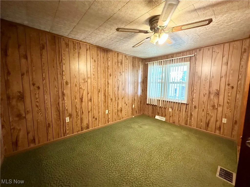 Bedroom with a ceiling fan and carpet floors