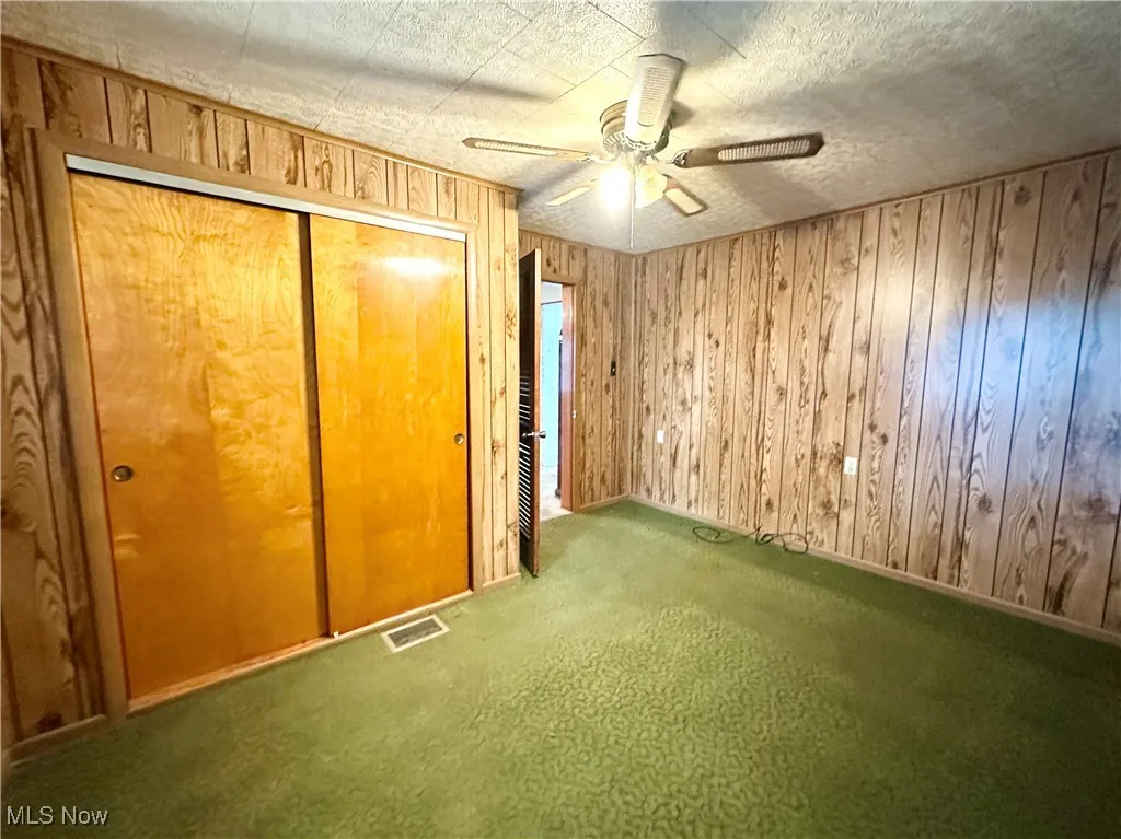 Bedroom featuring carpet, a closet, and ceiling fan