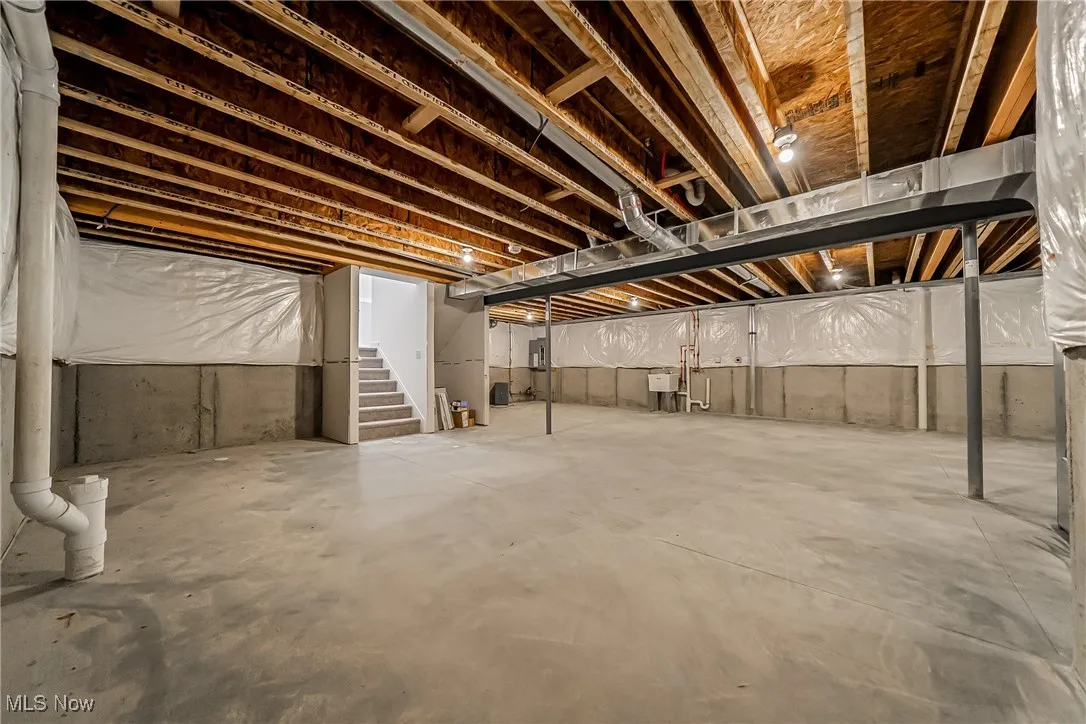 Unfinished basement featuring stairs
