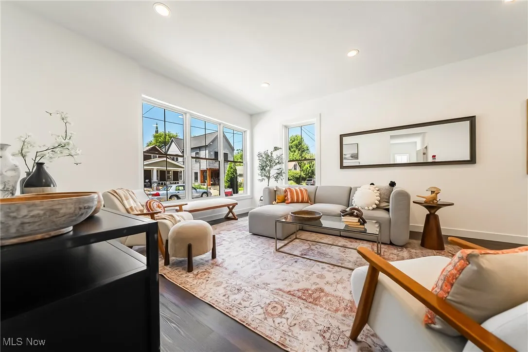 Living area with dark wood-style flooring and recessed lighting
