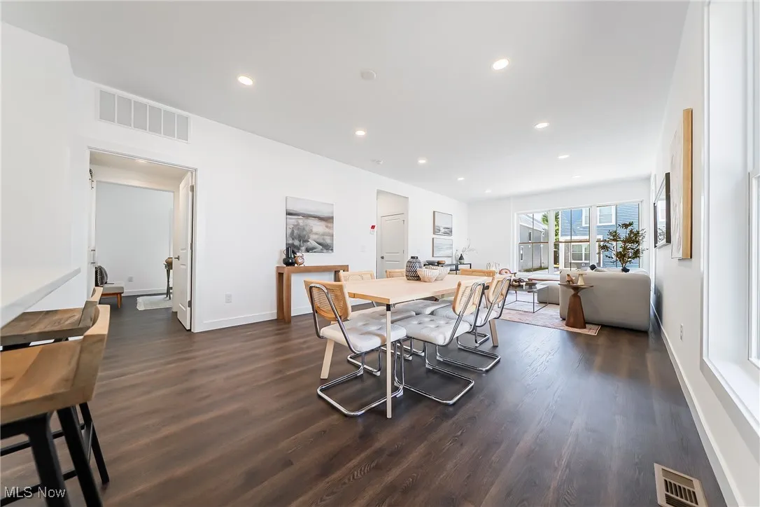 Dining area featuring recessed lighting and dark wood-style floors