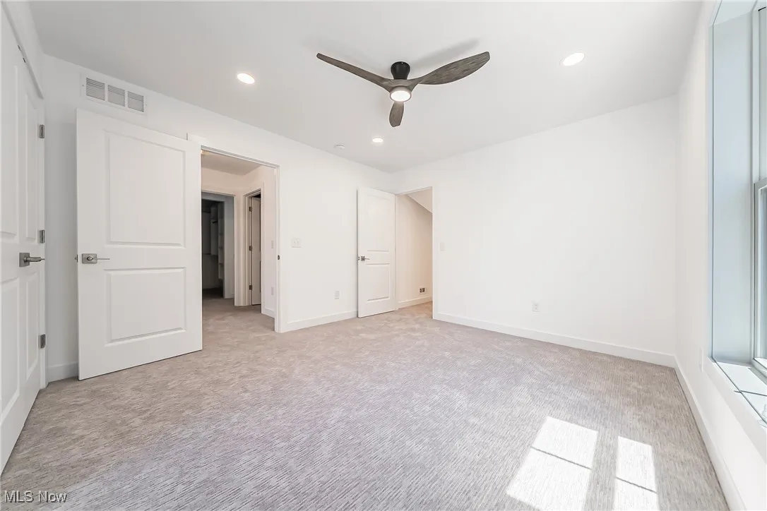 Bedroom featuring light carpet, recessed lighting, and ceiling fan