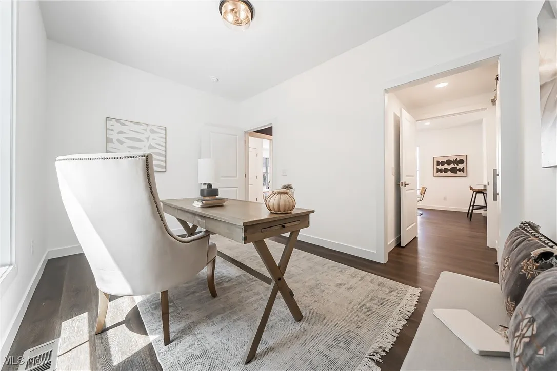 Bedroom or office featuring dark wood-style flooring and recessed lighting