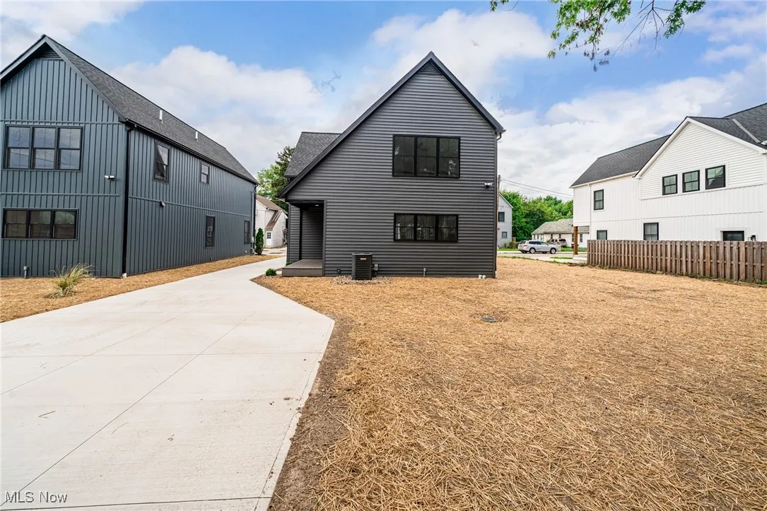 Rear view of property with concrete driveway