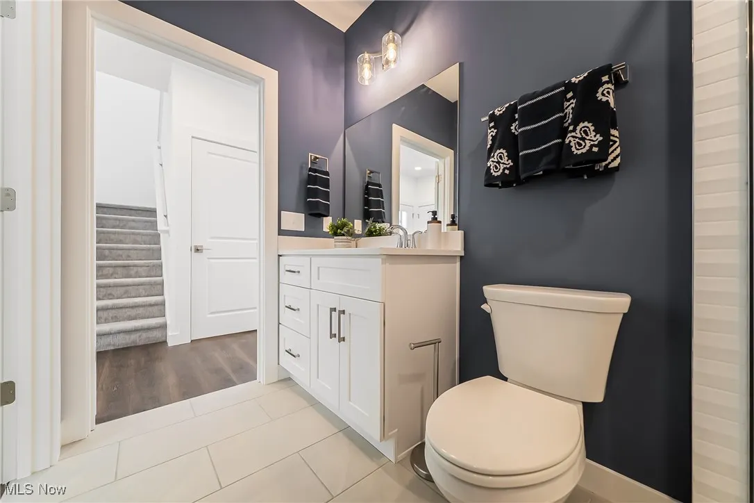Bathroom with light tile flooring and vanity