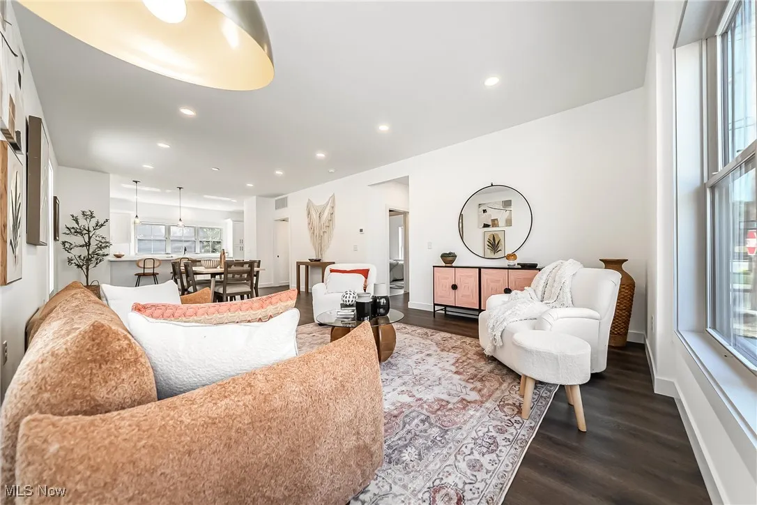 Living area featuring dark wood-style floors and recessed lighting