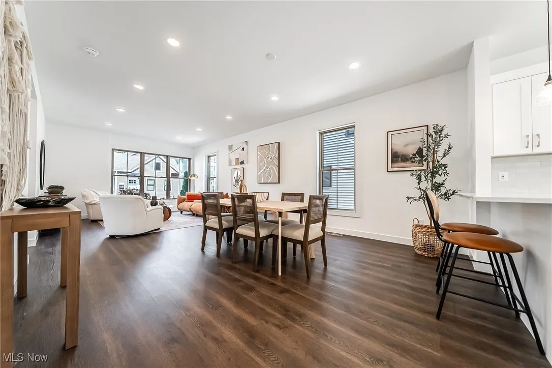 Dining space featuring dark wood-style floors and recessed lighting