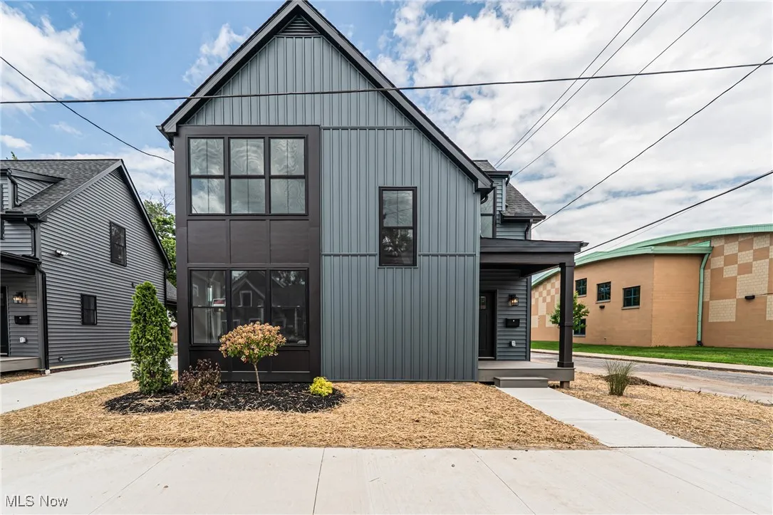 View of front of home featuring board and batten siding and covered porch