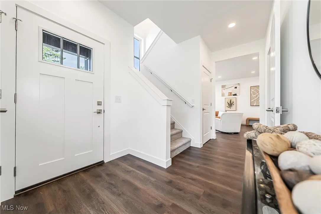Foyer with stairway, recessed lighting, and dark wood-style flooring