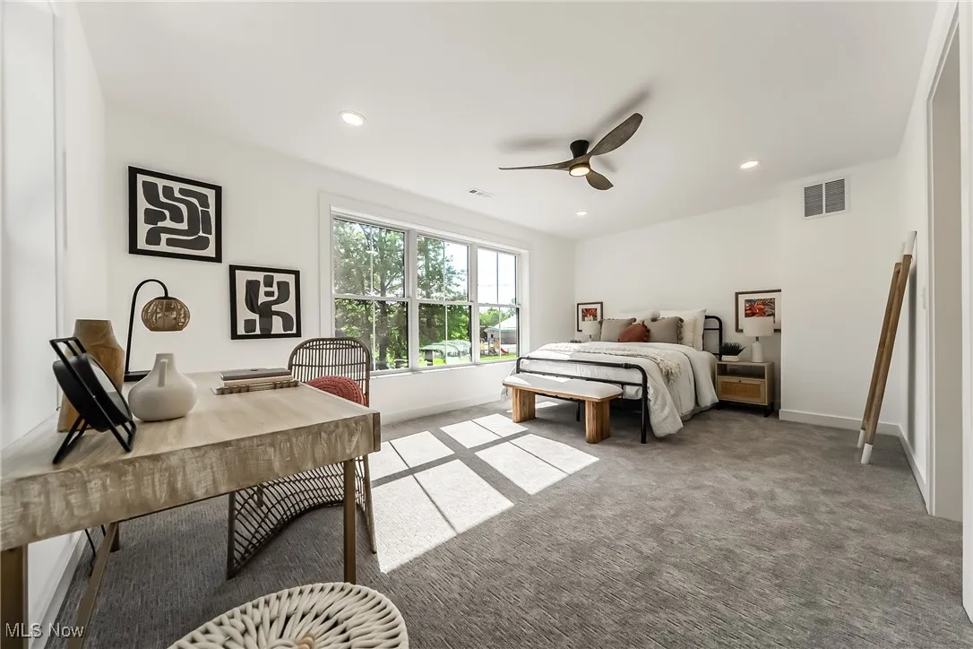 Primary bedroom with carpet floors, recessed lighting, and a ceiling fan