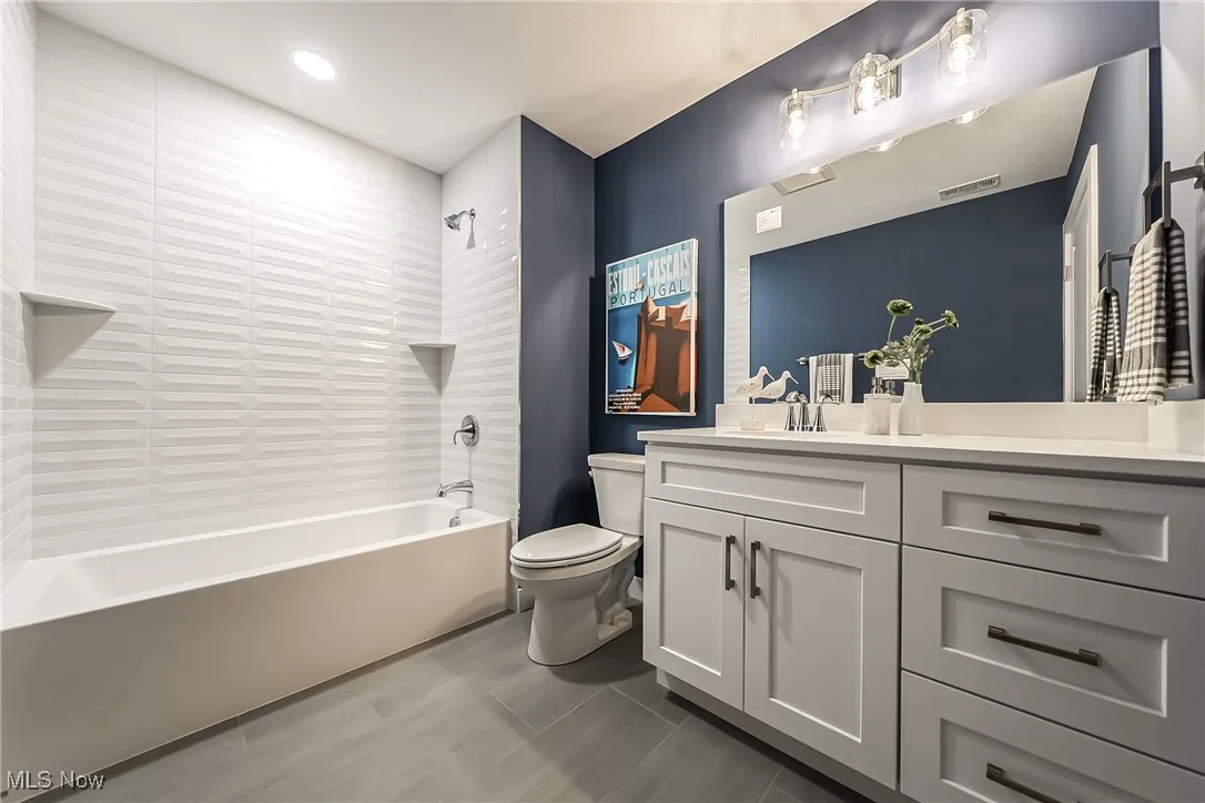 Bathroom featuring bathtub / shower combination and vanity