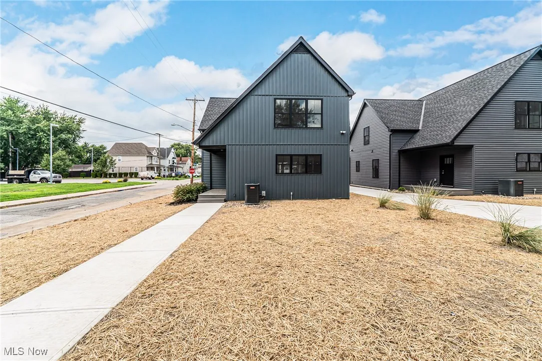Modern home with a shingled roof and board and batten siding