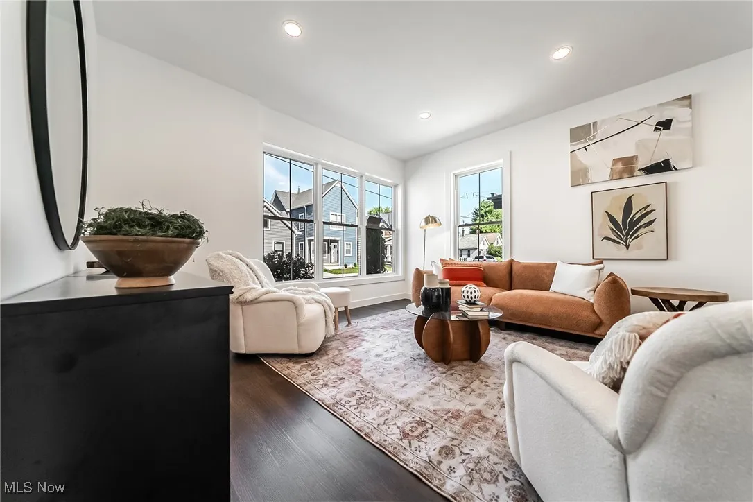 Living room with dark wood-style floors and recessed lighting