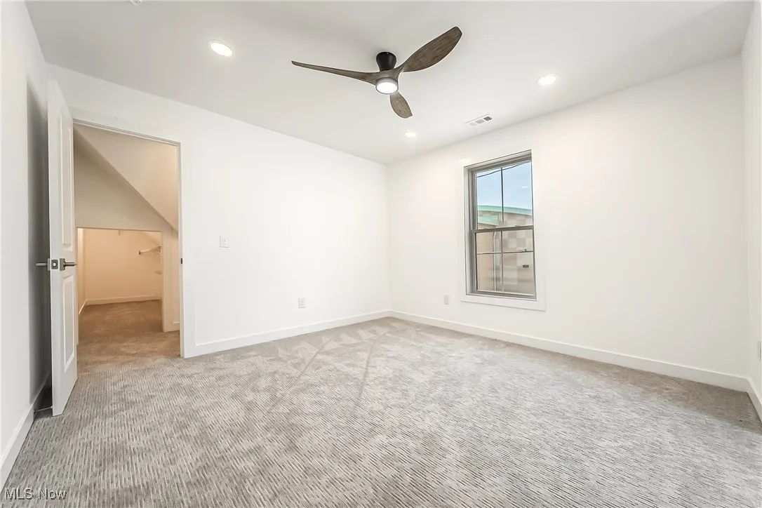 Bedroom featuring light carpet, a ceiling fan, and recessed lighting