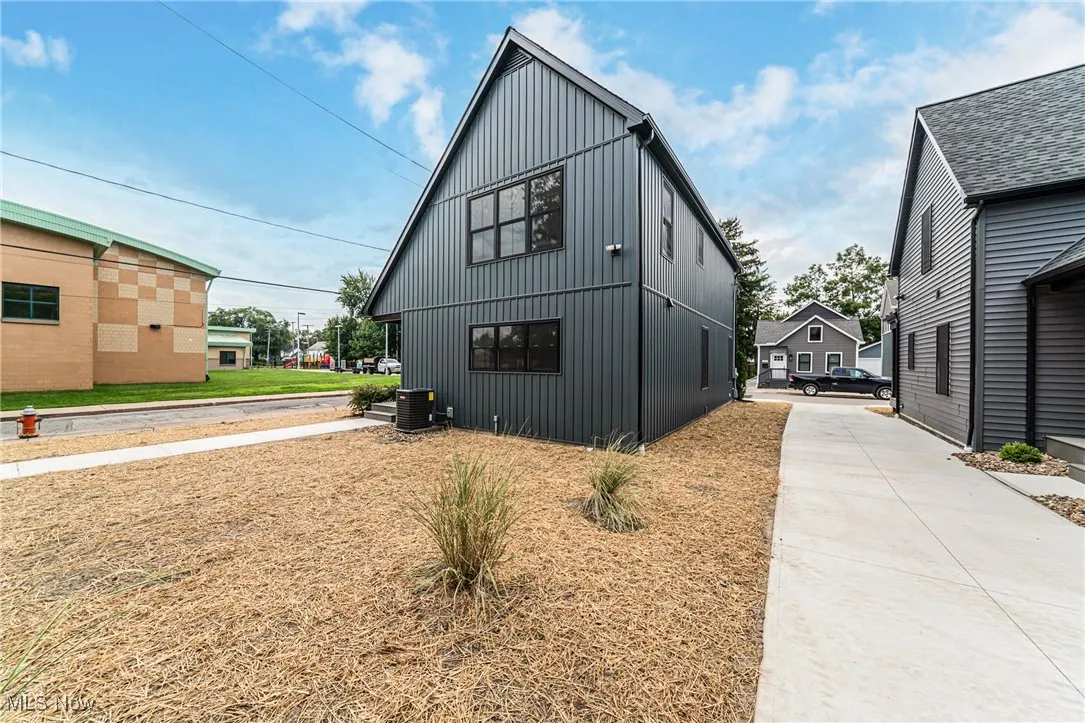 View of home's exterior featuring board and batten siding and a central air conditioning unit