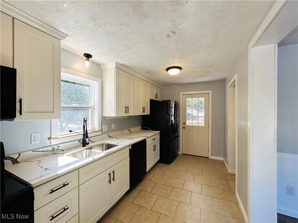 Kitchen featuring appliances and white cabinets