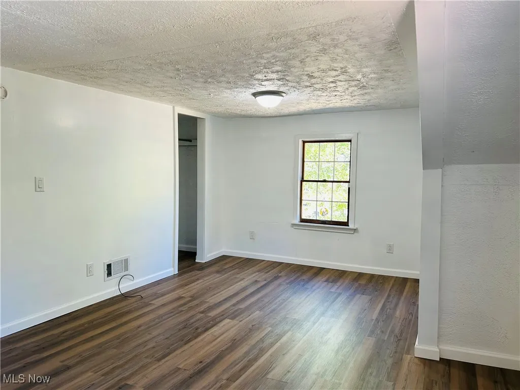 Bedroom with wood-style floors, and a closet