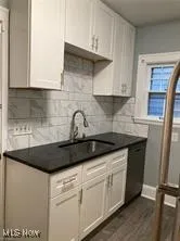 Kitchen featuring dark countertops, white cabinetry, and dark wood-style floors
