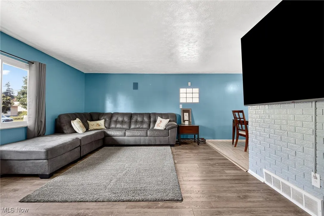 Living area featuring a textured ceiling and wood finished floors