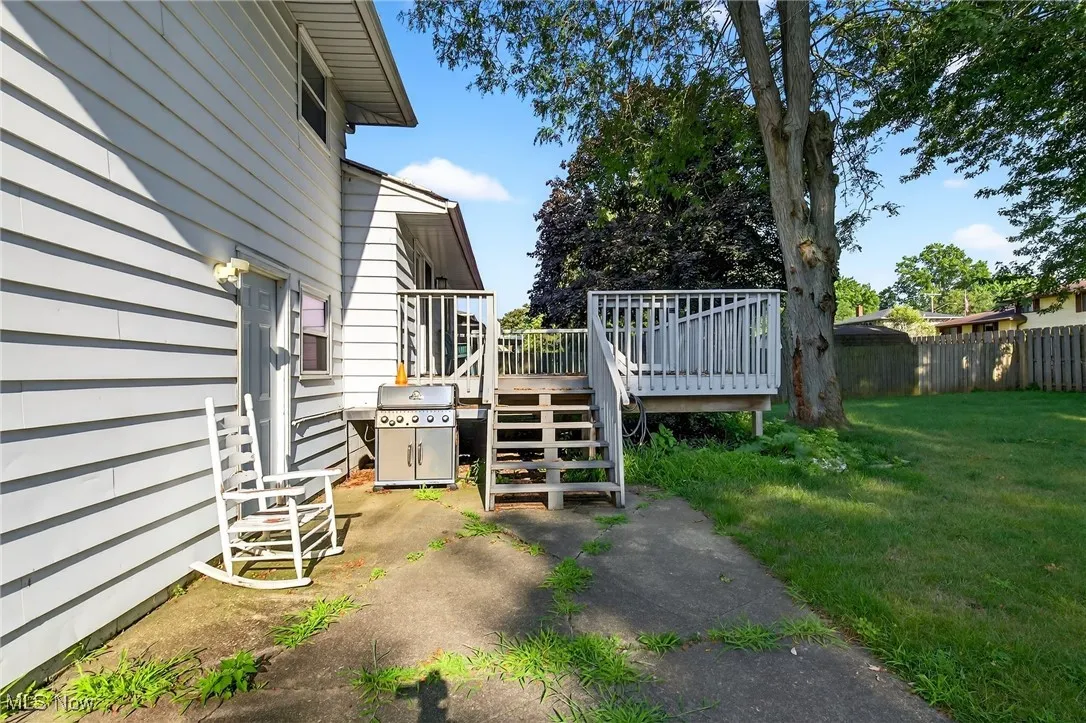 View of yard featuring a deck and stairs