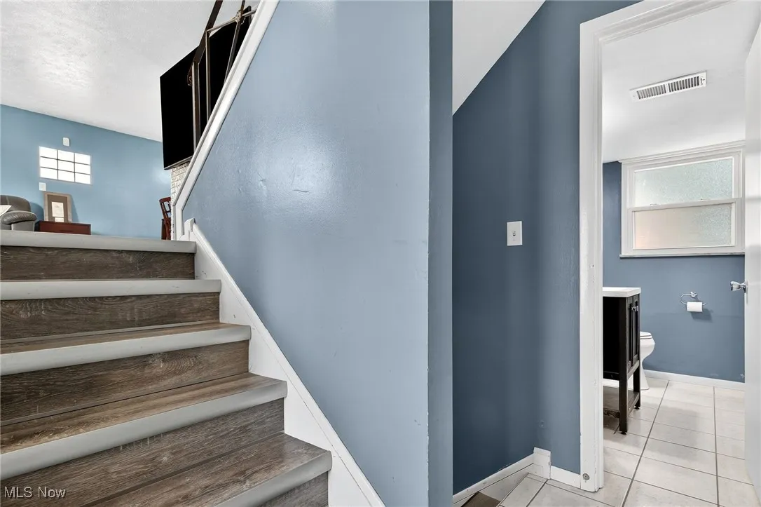 Stairs featuring tile patterned flooring and baseboards