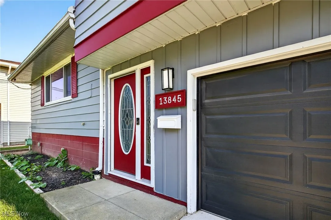 Doorway to property with a porch and board and batten siding