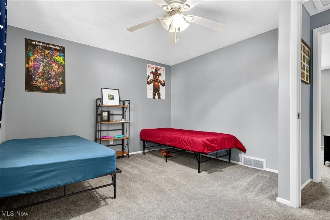 Bedroom featuring light colored carpet and ceiling fan
