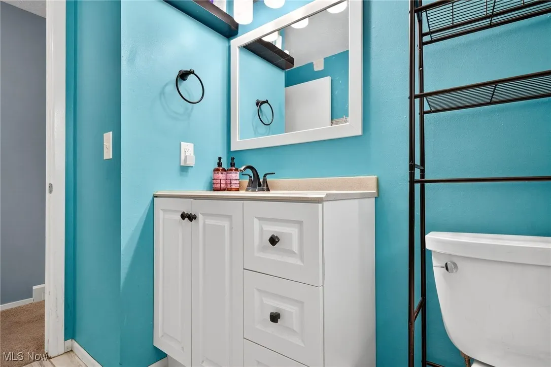 Bathroom featuring vanity and baseboards