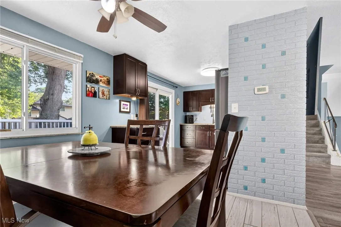 Dining room with light wood-type flooring and a ceiling fan